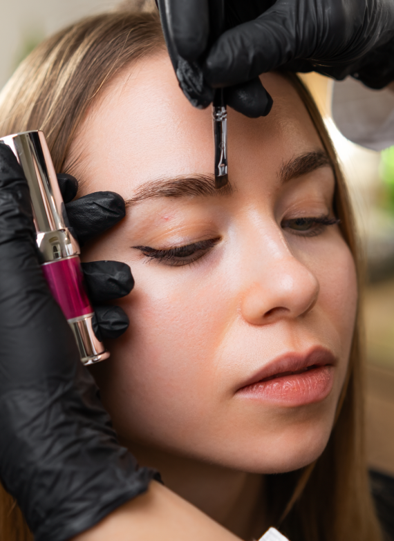 Permanent makeup near me – eyebrow lamination procedure with an artist carefully applying lifting formula for defined brows.